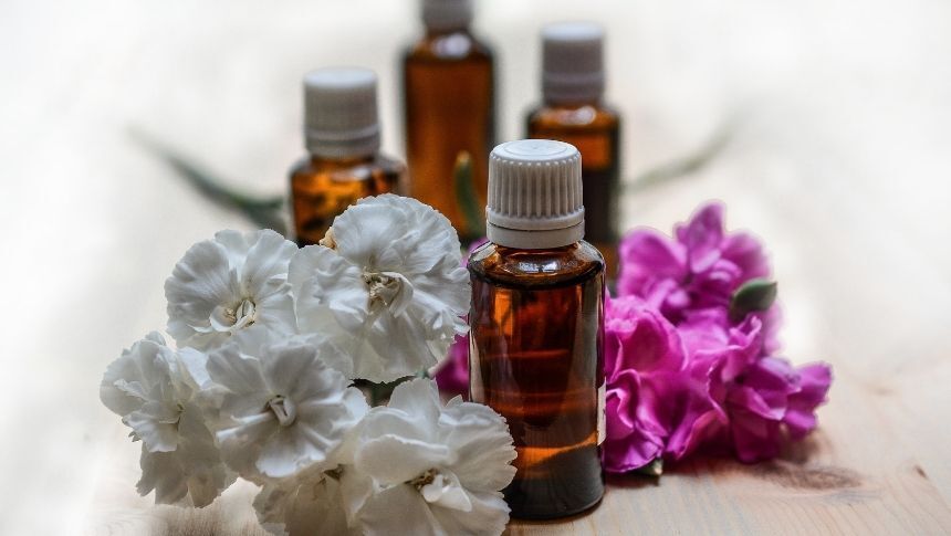 Image showing massage oils and flowers on display. massage oils